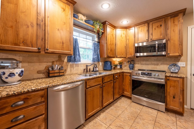 1021 W Whiteside St, Springfield, MO 65807 - kitchen with appliances with stainless steel finishes, brown cabinetry, decorative backsplash, and recessed lighting