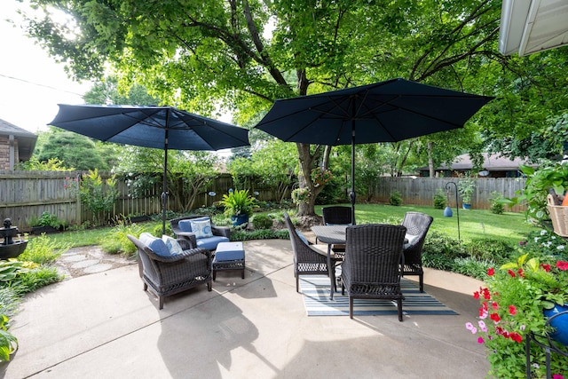 1021 W Whiteside St, Springfield, MO 65807 - fenced backyard featuring a patio, outdoor dining space, and outdoor lounge area