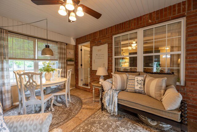 1021 W Whiteside St, Springfield, MO 65807 - living room with brick wall, a ceiling fan, and tile patterned flooring