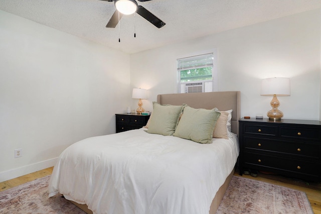 303 E Berkeley St, Springfield, MO 65807 - bedroom featuring light wood-type flooring, a ceiling fan, and a textured ceiling