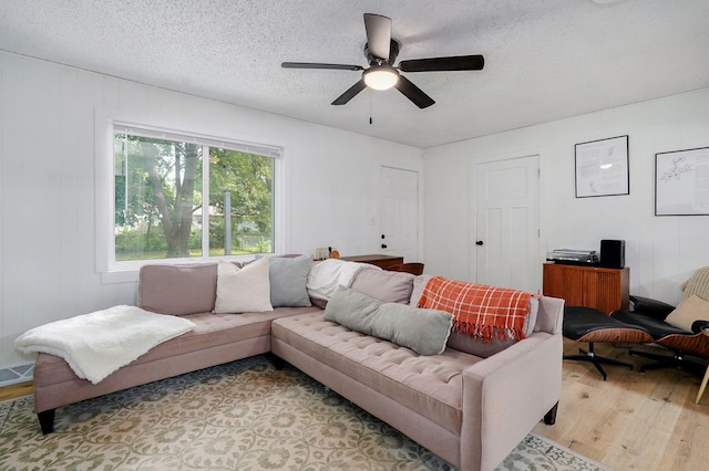 303 E Berkeley St, Springfield, MO 65807 - living room with light wood-style flooring, a ceiling fan, and a textured ceiling