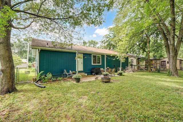 303 E Berkeley St, Springfield, MO 65807 - rear view of property featuring a patio and an outdoor fire pit