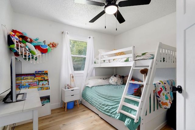 303 E Berkeley St, Springfield, MO 65807 - bedroom featuring wood finished floors, a textured ceiling, and a ceiling fan