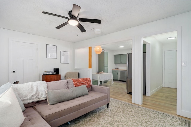 303 E Berkeley St, Springfield, MO 65807 - living area featuring light wood-style flooring, ceiling fan, and a textured ceiling