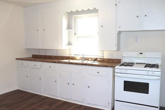 112 W Summit Ave, Seymour, MO 65746 - kitchen featuring white range with gas stovetop, dark countertops, white cabinets, and dark wood-type flooring