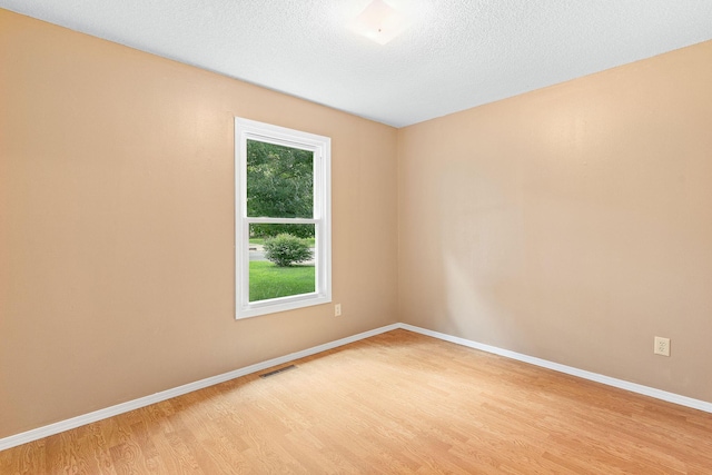 502 Sunrise St, Strafford, MO 65757 - empty room featuring light wood-style flooring and a textured ceiling