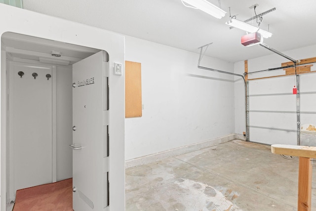 502 Sunrise St, Strafford, MO 65757 - garage featuring a garage door opener and baseboards