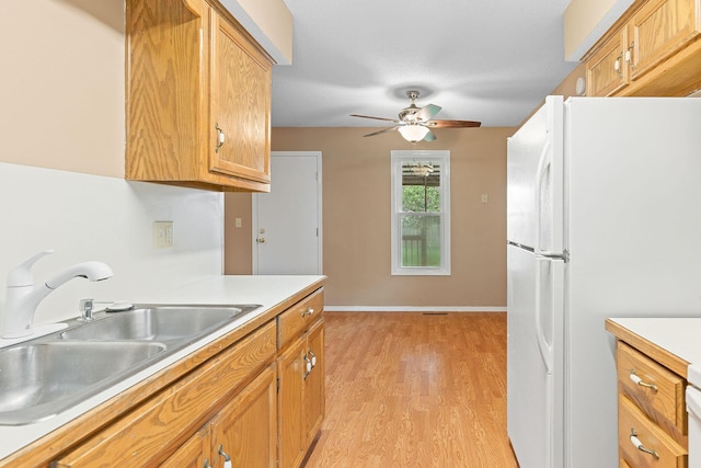 502 Sunrise St, Strafford, MO 65757 - kitchen featuring freestanding refrigerator, light countertops, light wood-style floors, a ceiling fan, and brown cabinets