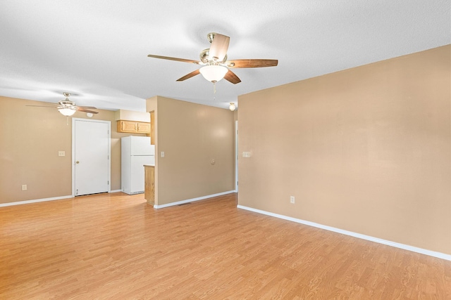 502 Sunrise St, Strafford, MO 65757 - unfurnished living room with a ceiling fan and light wood-style flooring
