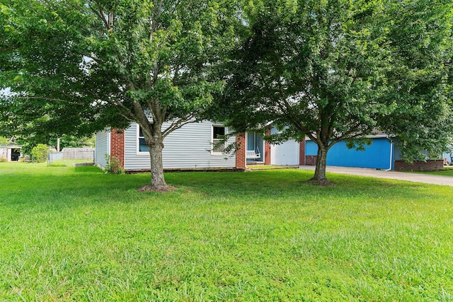 502 Sunrise St, Strafford, MO 65757 - obstructed view of property with concrete driveway, an attached garage, and brick siding