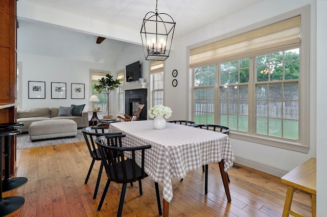 1421 N Rockingham Ave, Nixa, MO 65714 - dining room featuring hardwood / wood-style floors, a fireplace, and a chandelier