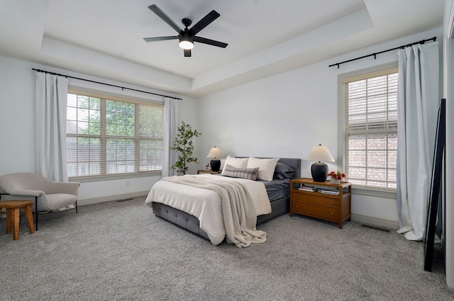 1421 N Rockingham Ave, Nixa, MO 65714 - carpeted bedroom featuring a tray ceiling and a ceiling fan