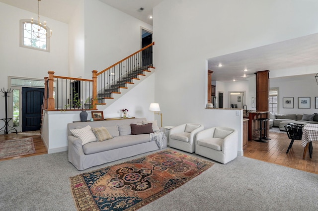 1421 N Rockingham Ave, Nixa, MO 65714 - carpeted living room featuring a towering ceiling, stairway, a chandelier, and recessed lighting