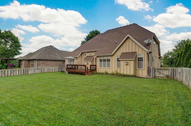 1421 N Rockingham Ave, Nixa, MO 65714 - back of house featuring board and batten siding, a fenced backyard, a deck, a gate, and roof with shingles