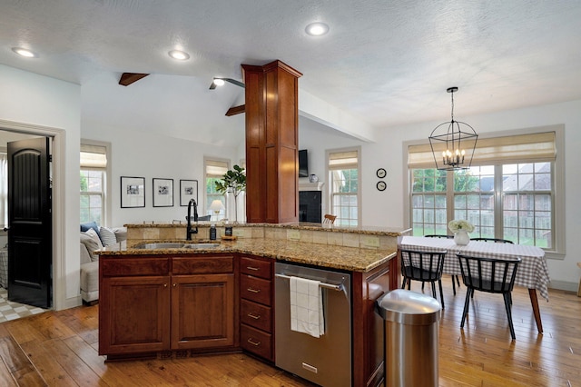 1421 N Rockingham Ave, Nixa, MO 65714 - kitchen with stainless steel dishwasher, light wood-type flooring, vaulted ceiling, a chandelier, and light stone counters