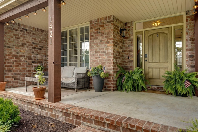 1421 N Rockingham Ave, Nixa, MO 65714 - doorway to property featuring a porch and brick siding