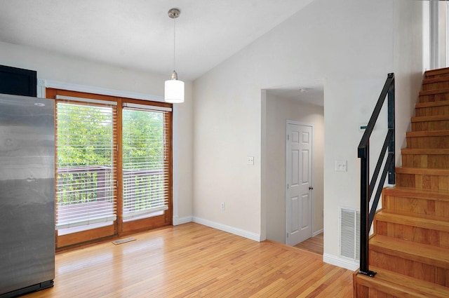 2001 S 16th Ave, Ozark, MO 65721 - unfurnished room with wood finished floors, stairs, and vaulted ceiling