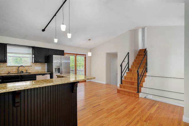 2001 S 16th Ave, Ozark, MO 65721 - kitchen featuring a breakfast bar area, light wood-style floors, stainless steel appliances, dark cabinets, and lofted ceiling
