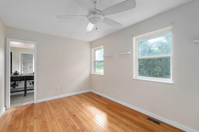 2001 S 16th Ave, Ozark, MO 65721 - unfurnished bedroom featuring light wood finished floors, a desk, and a ceiling fan