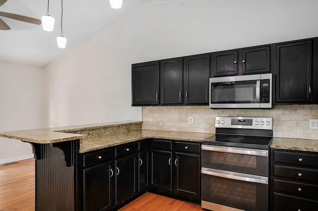 2001 S 16th Ave, Ozark, MO 65721 - kitchen featuring stainless steel appliances, dark cabinetry, light wood-type flooring, a peninsula, and lofted ceiling