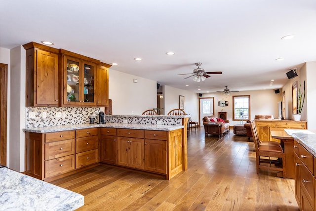 120 E Kennedy Blvd, Buffalo, MO 65622 - kitchen featuring a peninsula, recessed lighting, brown cabinetry, ceiling fan, and open floor plan