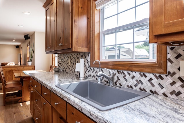 120 E Kennedy Blvd, Buffalo, MO 65622 - kitchen with decorative backsplash, recessed lighting, brown cabinetry, and wood finished floors