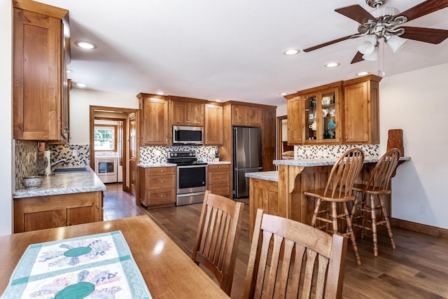 120 E Kennedy Blvd, Buffalo, MO 65622 - kitchen featuring brown cabinets, a peninsula, stainless steel appliances, tasteful backsplash, and recessed lighting