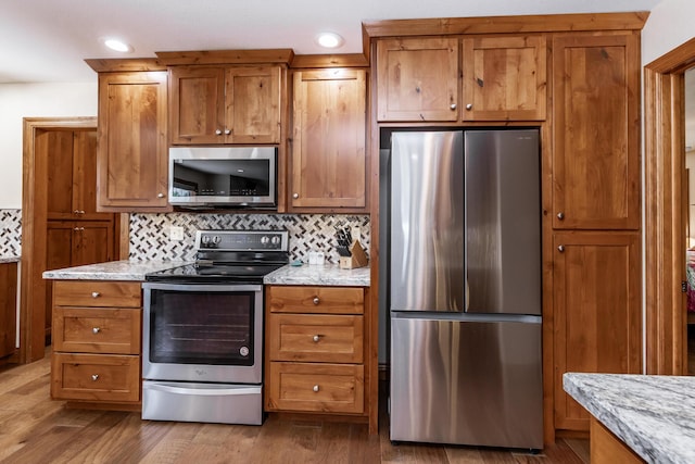 120 E Kennedy Blvd, Buffalo, MO 65622 - kitchen featuring appliances with stainless steel finishes, brown cabinetry, tasteful backsplash, and recessed lighting