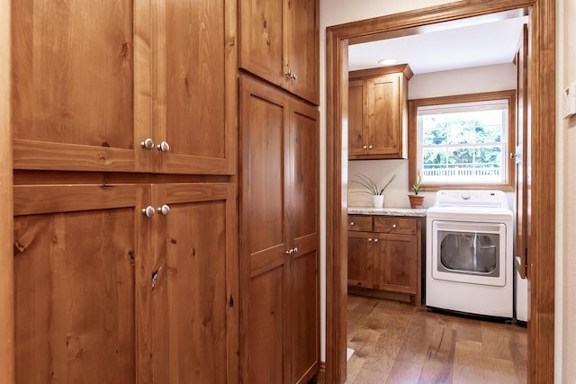 120 E Kennedy Blvd, Buffalo, MO 65622 - laundry area featuring cabinet space, washer / dryer, and light wood-style floors