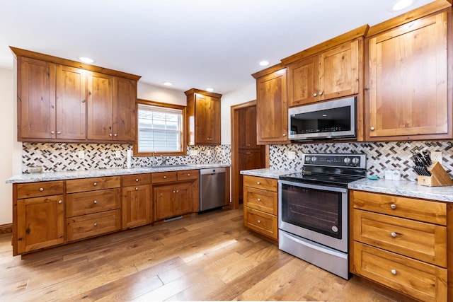 120 E Kennedy Blvd, Buffalo, MO 65622 - kitchen with stainless steel appliances, brown cabinetry, light wood-style floors, and recessed lighting