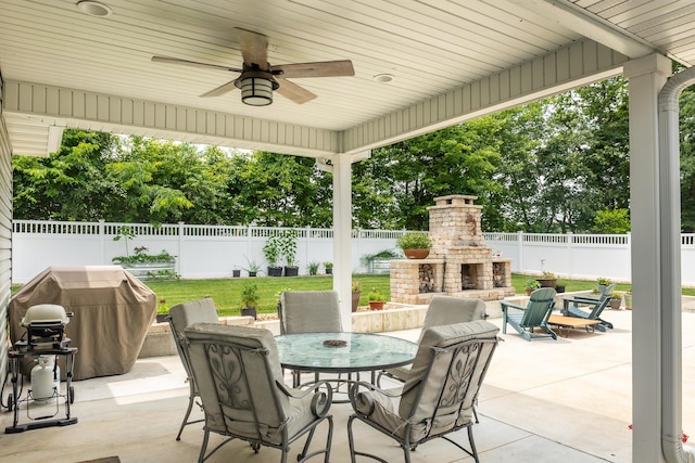 120 E Kennedy Blvd, Buffalo, MO 65622 - fenced backyard with an outdoor brick fireplace, a patio, a grill, a ceiling fan, and outdoor dining area