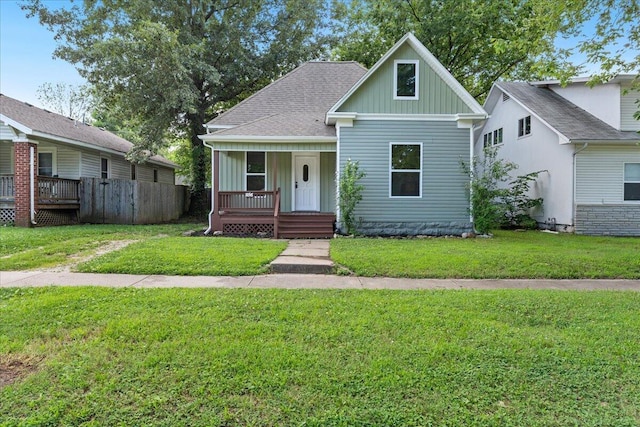 1156 W Lynn St, Springfield, MO 65802 - bungalow-style home featuring board and batten siding, covered porch, a front yard, and a shingled roof