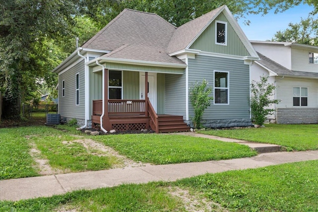 1156 W Lynn St, Springfield, MO 65802 - bungalow-style house with a porch, board and batten siding, a front yard, and roof with shingles