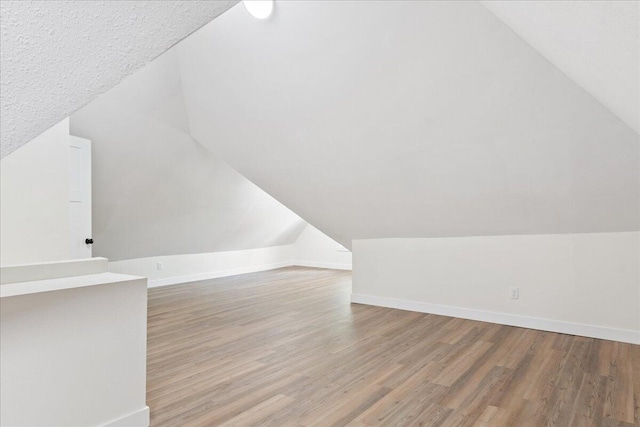 1156 W Lynn St, Springfield, MO 65802 - additional living space with vaulted ceiling and wood finished floors