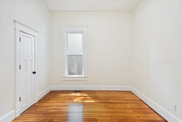 1156 W Lynn St, Springfield, MO 65802 - empty room with light wood-style flooring and baseboards