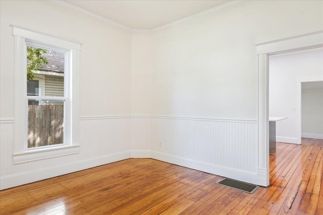 1156 W Lynn St, Springfield, MO 65802 - unfurnished room featuring light wood-type flooring and crown molding