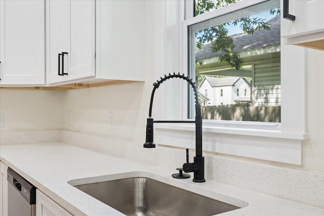 1156 W Lynn St, Springfield, MO 65802 - kitchen view of white cabinetry, light stone countertops, and dishwasher