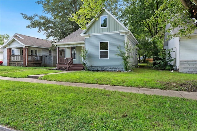 1156 W Lynn St, Springfield, MO 65802 - bungalow-style house featuring board and batten siding, a front lawn, a porch, and a shingled roof