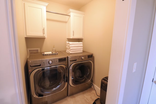 1224 S Mulberry Ave, Springfield, MO 65802 - washroom featuring washing machine and dryer, cabinet space, and light tile patterned floors