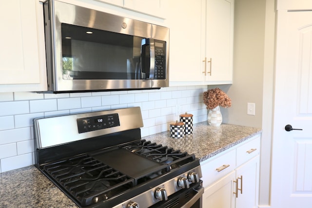 1224 S Mulberry Ave, Springfield, MO 65802 - kitchen with stainless steel appliances, white cabinetry, decorative backsplash, and light stone counters