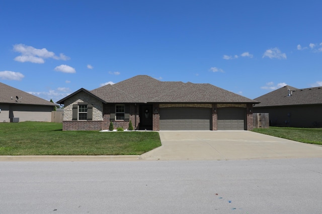 1224 S Mulberry Ave, Springfield, MO 65802 - view of front facade featuring an attached garage, brick siding, driveway, and a front lawn
