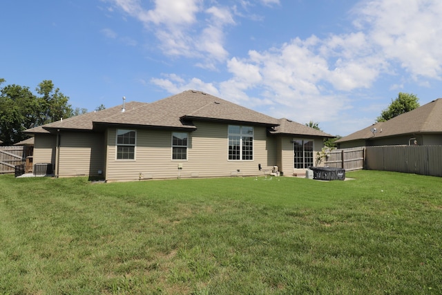 1224 S Mulberry Ave, Springfield, MO 65802 - rear view of house with a shingled roof and a fenced backyard