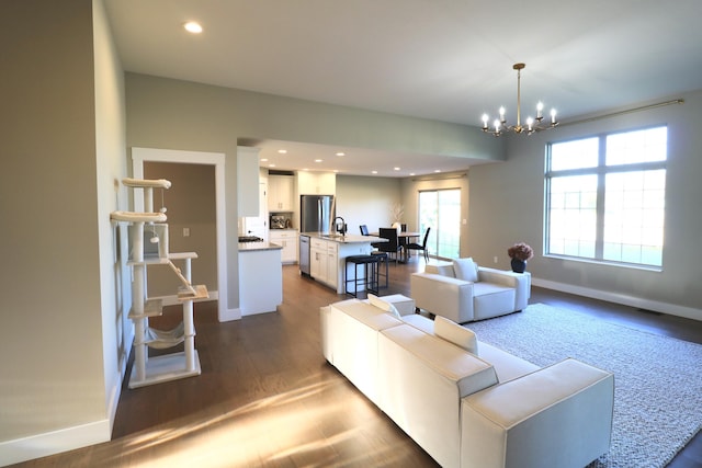 1224 S Mulberry Ave, Springfield, MO 65802 - living room featuring a chandelier, dark wood finished floors, and recessed lighting