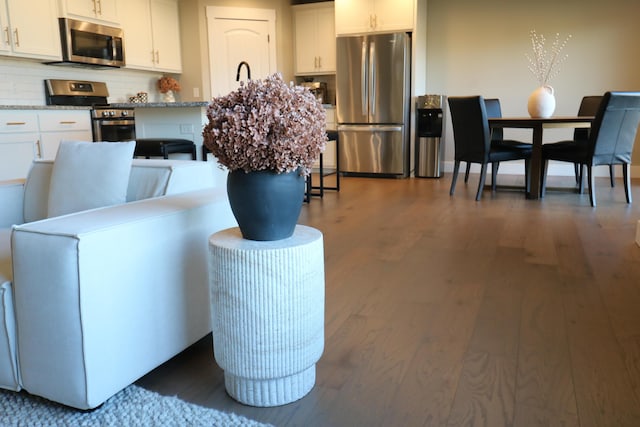 1224 S Mulberry Ave, Springfield, MO 65802 - kitchen featuring stainless steel appliances, dark wood-style flooring, white cabinets, and backsplash