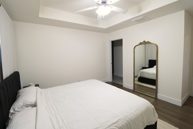 1224 S Mulberry Ave, Springfield, MO 65802 - bedroom featuring a tray ceiling, dark wood-style flooring, and ceiling fan
