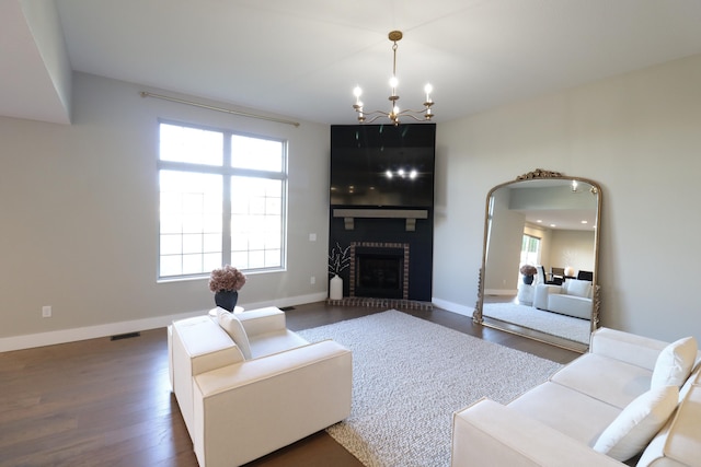 1224 S Mulberry Ave, Springfield, MO 65802 - living area featuring dark wood-style floors, a chandelier, and a fireplace