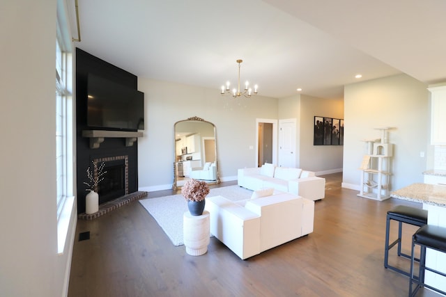 1224 S Mulberry Ave, Springfield, MO 65802 - living area with dark wood finished floors, arched walkways, a brick fireplace, recessed lighting, and a chandelier