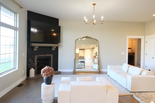 1224 S Mulberry Ave, Springfield, MO 65802 - living area featuring a chandelier, healthy amount of natural light, wood finished floors, and washer / clothes dryer