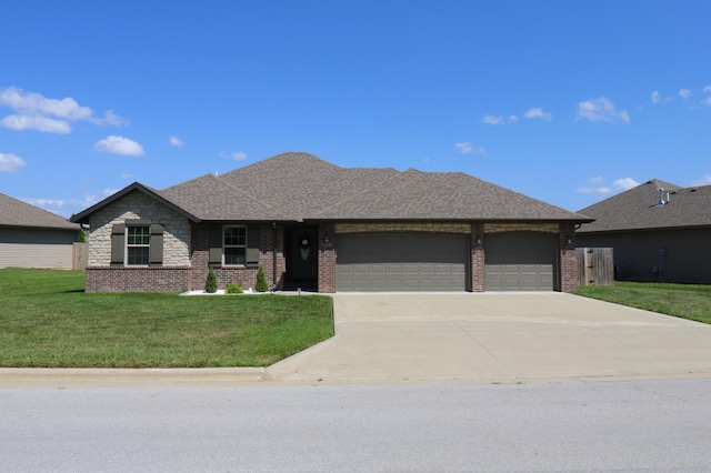 1224 S Mulberry Ave, Springfield, MO 65802 - view of front of property with a shingled roof, an attached garage, brick siding, a front lawn, and driveway