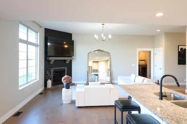1224 S Mulberry Ave, Springfield, MO 65802 - kitchen featuring a fireplace, a chandelier, wood finished floors, recessed lighting, and open floor plan